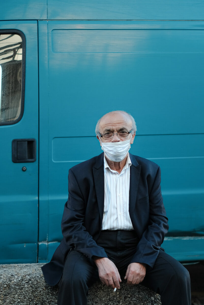 Olga Serjantu_A man sitting in front of a vehicle